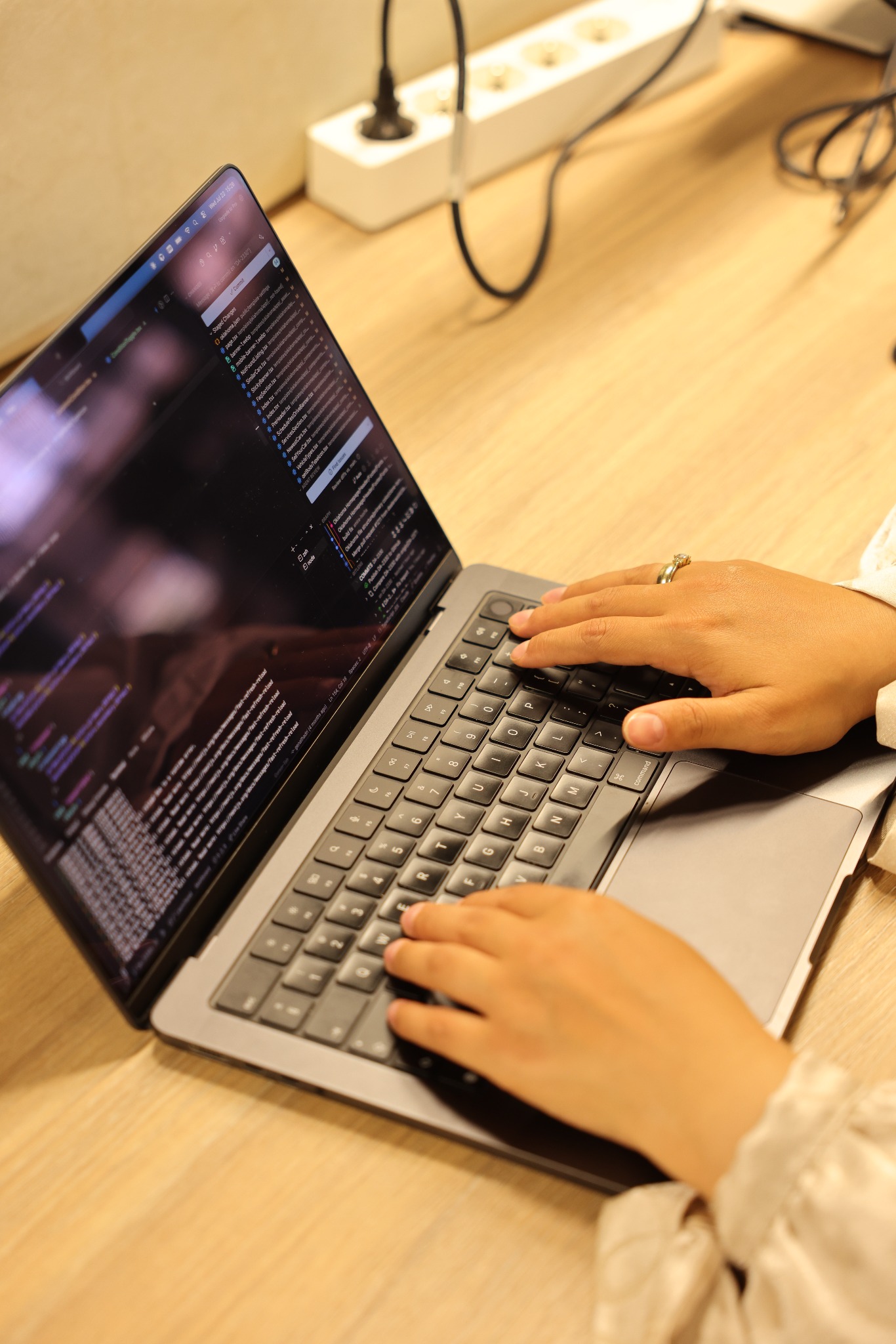 Close-up of Amira writing frontend code on her laptop